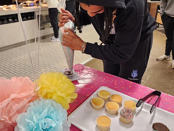 student decorating their own cupcake